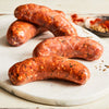 Image of California Chicken Chorizo. 4 links, about 1 lb. this uncooked California-style sausage is a blend of chicken and pork seasoned with red pepper puree and a variety of spices