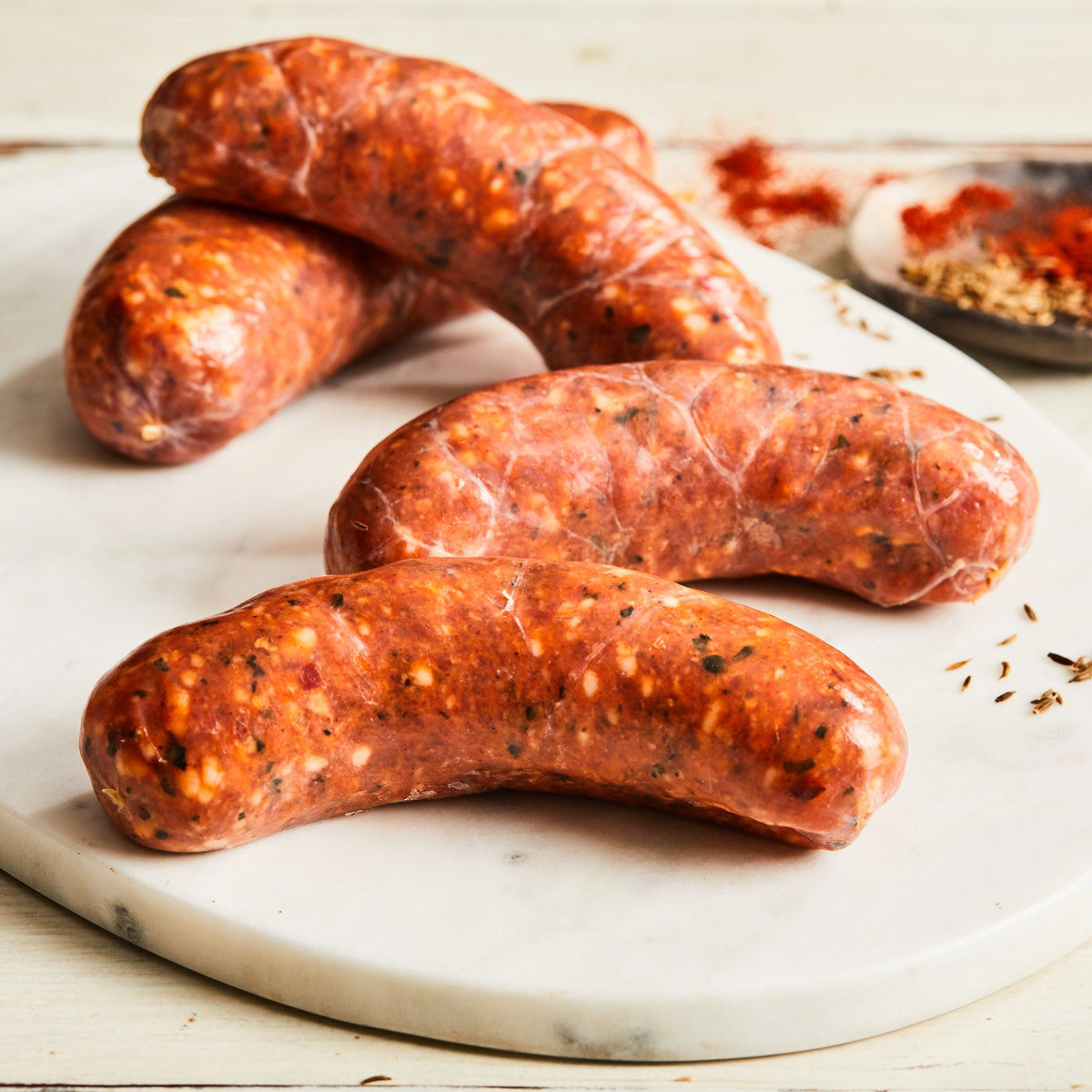 Image of California Chicken Chorizo. 4 links, about 1 lb. this uncooked California-style sausage is a blend of chicken and pork seasoned with red pepper puree and a variety of spices