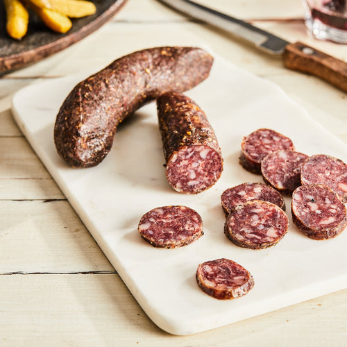 Image of Saucisson Sec with Herbs de Provence. 1 link, 3 oz. a traditional French pork salami with black pepper, pink pepper, garlic, and herbs de Provence