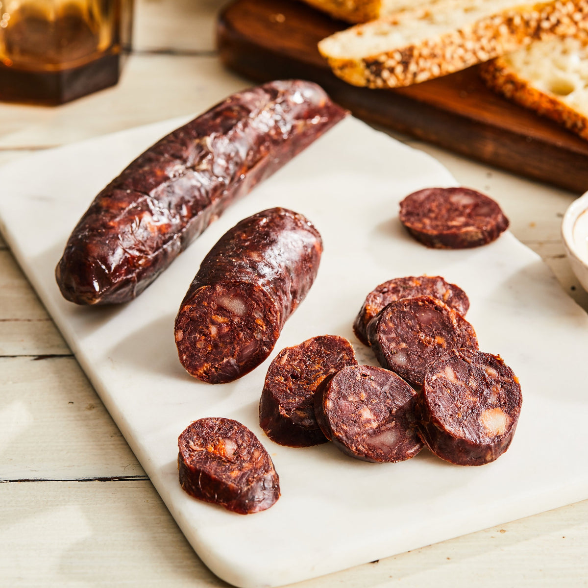 Image of Noir Salami. 1 link, 3 oz. a French-style pork salami with caramelized onion, black pepper, cinnamon, ginger, and pig's blood